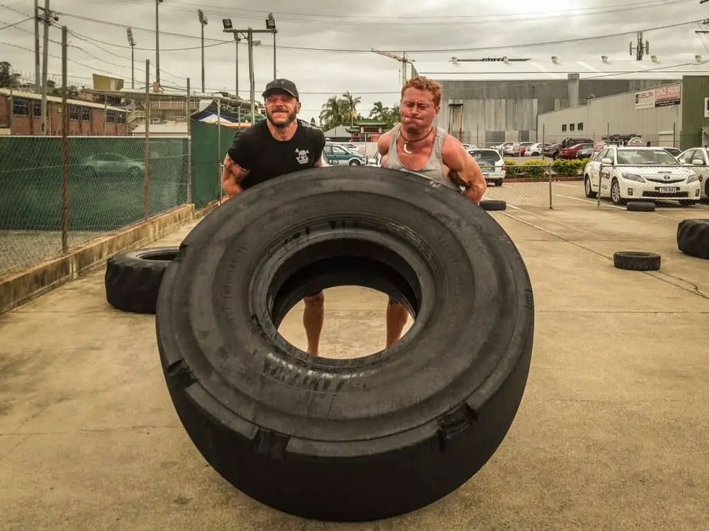 2 men flipping a tire