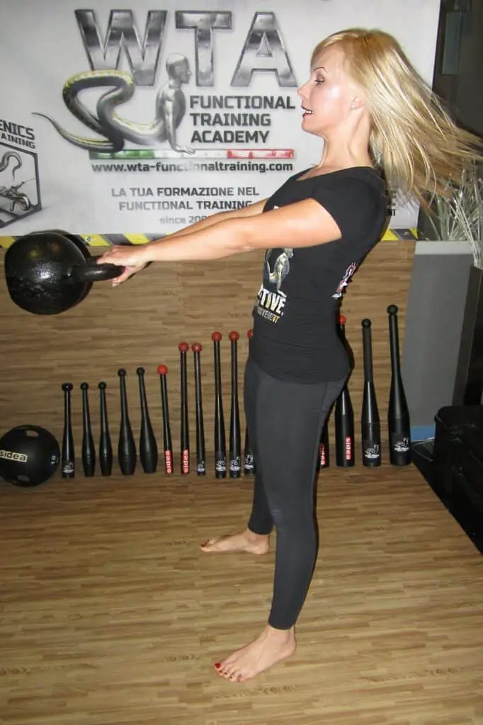 Woman exercising doing kettle swing