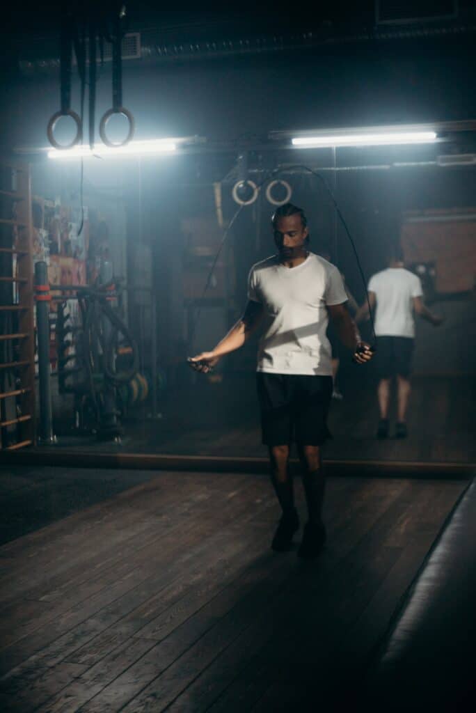 Man exercising in the gym doing doing jump rope