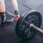 Person lifting a barbell with weights