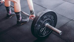 Person lifting a barbell with weights