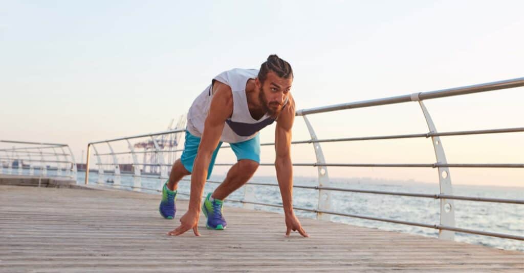 young sporty bearded man at the seaside prepare for the shuttle run