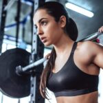 young sporty woman is working out in gym