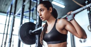 young sporty woman is working out in gym